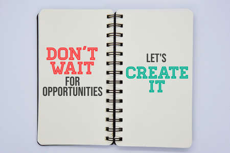 'Don't wait for opportunities, let's create it' quote on double side notebook with white background concept.の写真素材