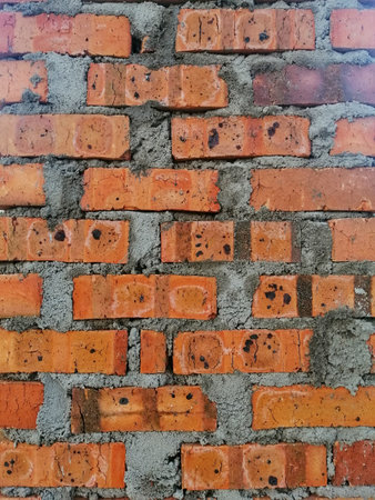 Background texture of dried clay bricks wall. Image contain grains of cement and clay.の写真素材