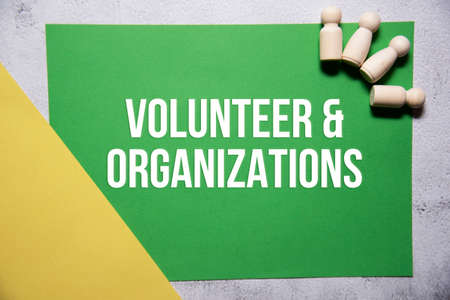 Volunteer and organizations text on green and yellow background flat lay concept. Suitable to used...