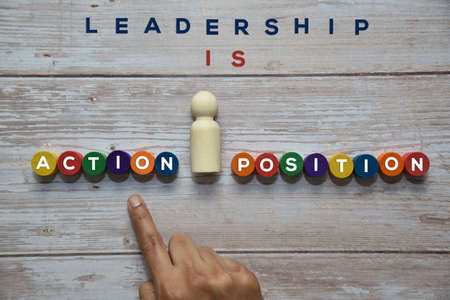 LEADERSHIP is ACTION and not a POSITION wording on the colorful wooden blocks with single wooden...