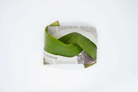 Temerloh, Pahang, Malaysia : 12nd September 2020 - Banana leaf and old newspaper used to cover Nasi Lemak. It is commonly found in Malaysia, where it is considered the national dishのeditorial素材