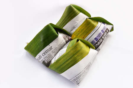 Temerloh, Pahang, Malaysia : 12nd September 2020 - Banana leaf and old newspaper used to cover Nasi Lemak. It is commonly found in Malaysia, where it is considered the national dishのeditorial素材