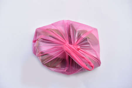 Nasi lemak is a Malay cuisine dish consisting of fragrant rice cooked in coconut milk and pandan leaf. Plastic beg used to packing it when buy more.のeditorial素材