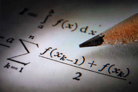 Writing math equations on a sheet of paper in monitorの写真素材