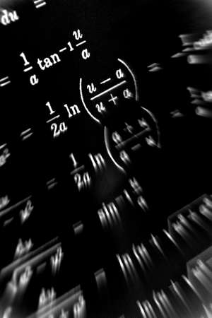 Large number of mathematical formulas focus zoom on a black backgroundの写真素材