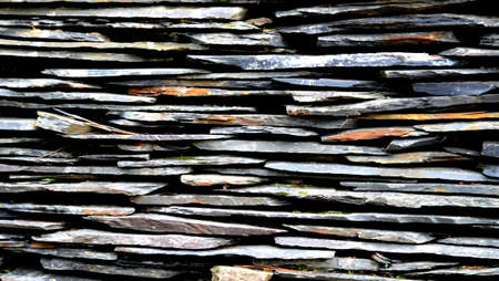 Close-up detail view of an old traditional stone wall built from schist in Piodão, made of shale rocks stack, one of Portugal's schist villages in the Aldeias do Xisto.の写真素材