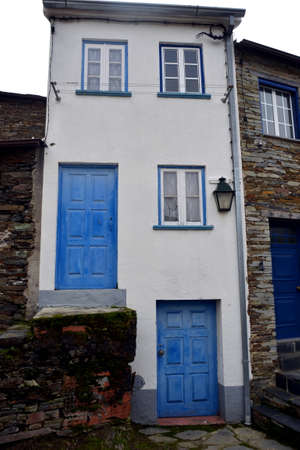Rustic hand-hewn wood door set into a stone wall built from schist in Piodão, made of shale rocks stack, one of Portugal's schist villages in the Aldeias do Xisto.のeditorial素材