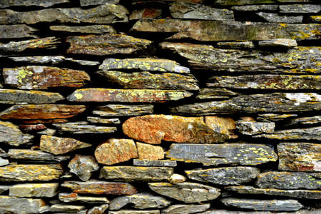 Close-up detail view of an old traditional stone wall built from schist in Piodão, made of shale rocks stack, one of Portugal's schist villages in the Aldeias do Xisto.の写真素材