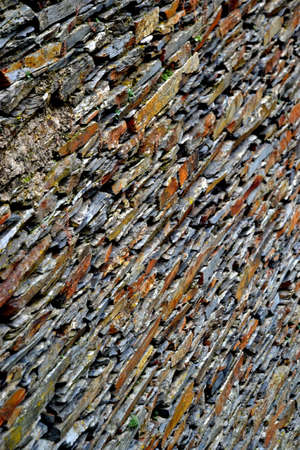 Close-up detail view of an old traditional stone wall built from schist in Piodão, made of shale rocks stack, one of Portugal's schist villages in the Aldeias do Xisto.の写真素材