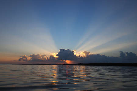 Sunrise and sun rays reflected in the waters of West Lake in Everglades National Park, Florida.
