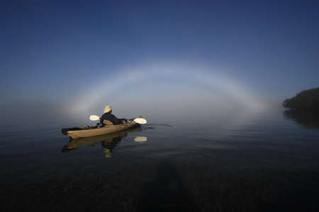 Key Biscayne, Florida 01-16-2016 Kayaker enjoys a bright fogbow ober Biscayne Bay on a calm, foggy morning.のeditorial素材