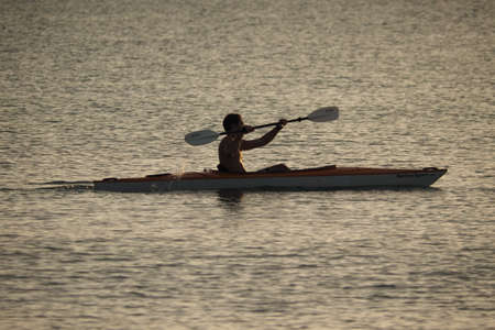 Captiva Island, Florida 08-05-2015 Young man kayaks off the beach in Captiva Island in partial...