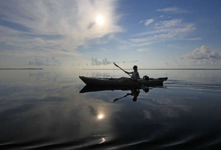 Biscayne National Park, Florida 07-27-2013 Woman kayaks on a perfectly still Biscayne Bay south of Miami, Florida.のeditorial素材