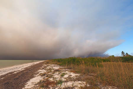 Smoke from a wildfire over the beach and Gulf of Mexico on East Cape Sable in Everglades National...