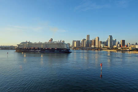Miami, Florida 11-10-2018 Cruise ship in the Port of Miami turning basin with the Miami skyline in the background on a calm and clear autumn morning.のeditorial素材