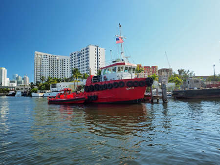 Miami, Florida 03-01-2019 Large red tugboat on the Miami River on a clear and sunny March afternoon.のeditorial素材