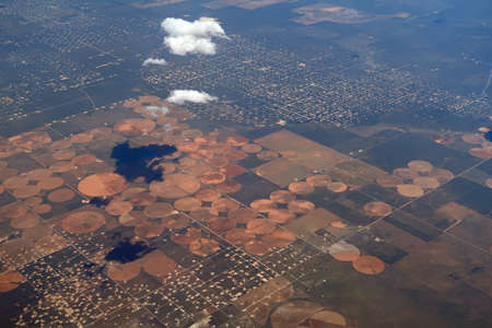 Aerial view of circular irrigated fields near the border between Utah and New Mexico.