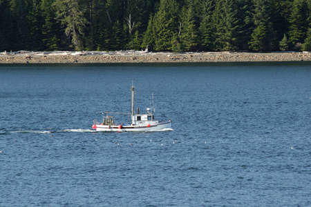 Inside Passage, Alaska - August 5, 2006 - Workboat cruises waters of Inside Passage on sunny summer day.のeditorial素材