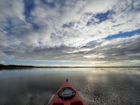 Sunset cloudscape and reflections on Coot Bay in Everglades National Park, Florida on a calm winter evening.の写真素材