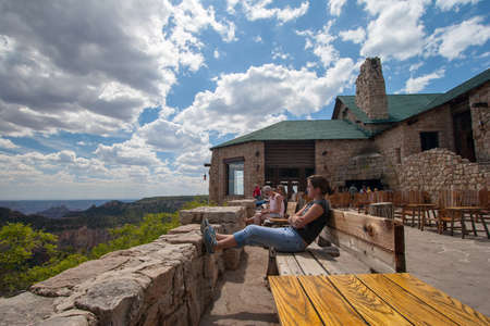 Grand canyon National Park, Arizona - June 14, 2005 - Tourists enjoy scene of Canyon North Rim from terrace of Grand Canyon Lodge on summer afternoon.のeditorial素材