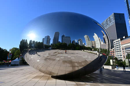 Chicago, Illinois 08-09-19 Cloud Gate sculpture by Anish Kapoor reflects surrounding buildings in...