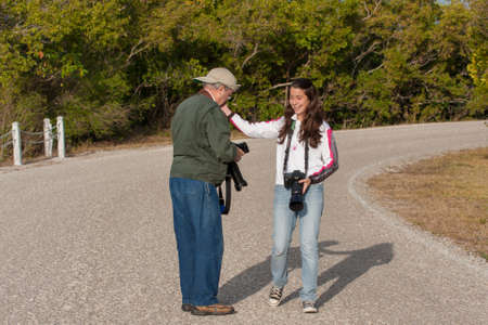 Sanibel Island, Florida - February 8, 2009: Man and granddaughter enjoy photography in Ding Darling National Wildlife Refuge in winter.のeditorial素材