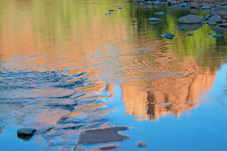 Brilliant reflections of Cathedral Rock on Oak Creek near Sedona, Arizona on cloudless summer...