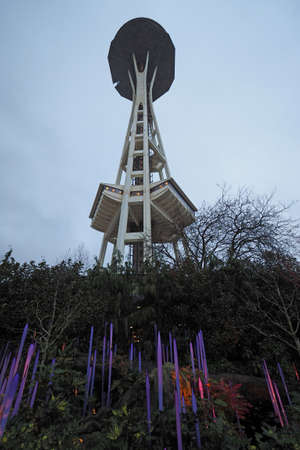 Seattle, Washington - February 8, 2018 - Space Needle against overdast winter sky with colorful Chihuly glass sculpture in foreground.のeditorial素材