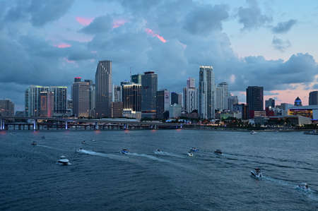 Miami, Florida - July 4, 2019 - Boats gather in front of City of Miami skyline at dusk ahead of Independence Day fireworks display.のeditorial素材