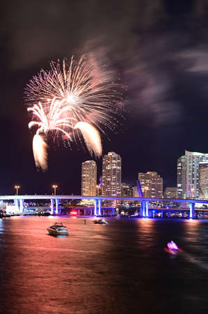 Miami, Florida - July 4, 2019 - Fireworks above City of Miami skyline reflected on Biscayne Bay.のeditorial素材