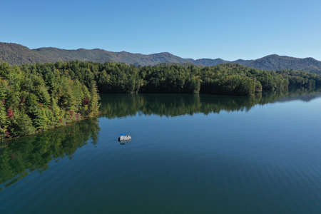 Aerial view of pontoon boat on Lake Santeetlah, North Carolina in autumn.の写真素材