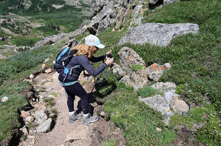 Woman descends King Lake Trail in Indian Peaks Wilderness in Arapaho National Forest, Colorado on...