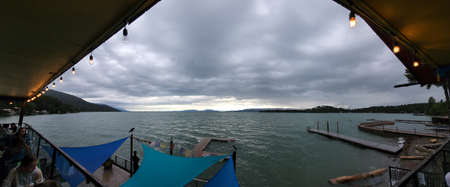 Bigfork, Montana - 6-21-2022 - Panoramic view of Flathead Lake from balcony on lakeside in late afternoon.のeditorial素材
