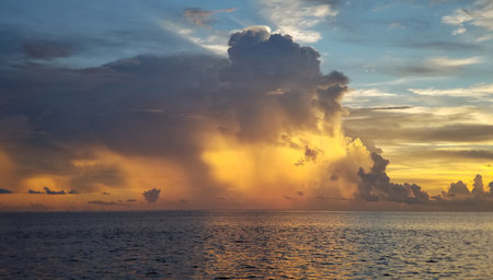 Colorful backlit storm clouds over Gulfstream off Miami, Florida at sunrise.