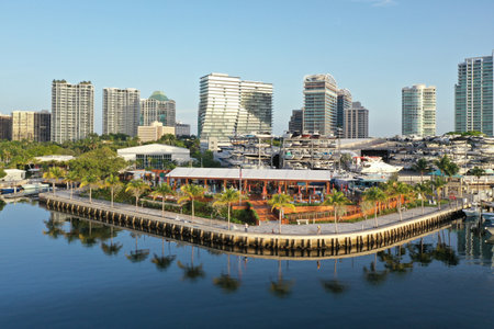 Aerial view of waterfront bars, restaurants and marina in Coconut Grove, Miami, Florida with skyline in background on calm clear sunny summer morning.の写真素材
