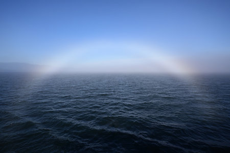 Bright fogbow in Juan de Fuca Strait off Port Angeles, Washington on sunny foggy summer morning.