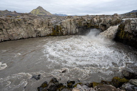 Innri-Emstrua River and waterfall in Fjallabak Nature Reserve in Icelandic highlands on sunny overcast autumn afternoon.の写真素材