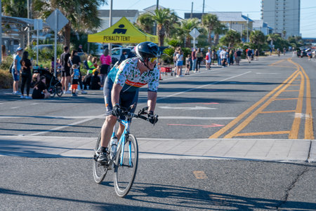 Panama City Beach, Florida - November 4, 2023 - Male athlete on bicycle in 2023 Ironman competition.のeditorial素材