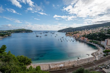 Yachts at anchor in natural harbor of Villefranche-sur-Mer on sunny summer afternoon.の写真素材