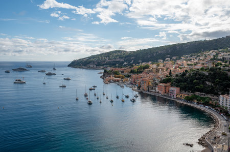 Yachts at anchor in natural harbor of Villefranche-sur-Mer on sunny summer afternoon.の写真素材