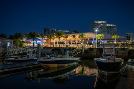 Bars and restaurants of Coconut Grove in Miami, Florida reflected in calm water of Biscayne Bay in deep morning twilight.の写真素材