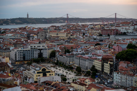 Lisbon, Portugal from Miradouro da Senhora do Monte in late afternoon light with Ponte Vinte e Cinco de Abril and Tagus River in background.の写真素材