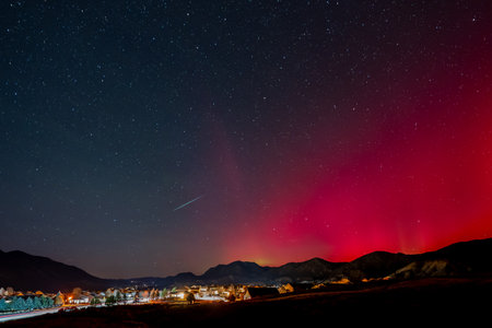 Red and green Aurora Borealis - Northern Lights - display and meteor over town of New Castle, Colorado of 11-11-2025.の写真素材