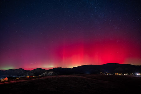 Red and green Aurora Borealis - Northern Lights - display over town of New Castle, Colorado of 11-11-2025.の写真素材