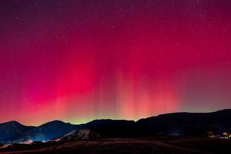 Red and green Aurora Borealis - Northern Lights - display over town of New Castle, Colorado of 11-11-2025.の写真素材