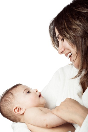 Mother holds baby in her arms looking at eachother eyes in tendernessの写真素材