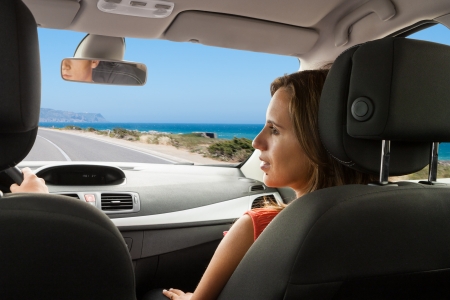 Couple enjoying their new car on a coastal roadの写真素材