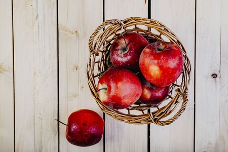 apple basket on wooden table top view