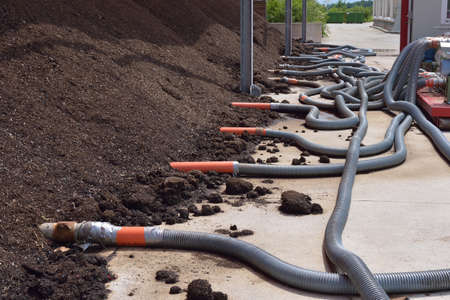 Industrial compost heap with forced aeration pipes 