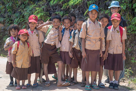 Mamasa, Sulawesi, Indonesia - August 16, 2014: Group of school children of Toraja ethnicity in brown uniform smiling while looking at the camera in the countryside of Mamasa, West Tana Toraja.のeditorial素材
